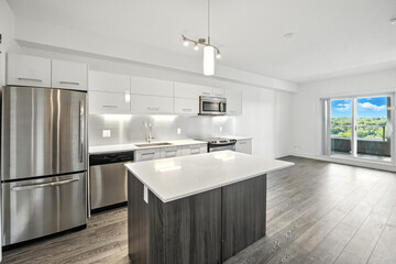 Kitchen with a stainless steel refrigerator, microwave, and sink