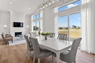 Large white dining table with a white tablecloth