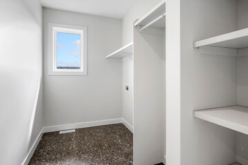 Small, empty room with a window and a white closet
