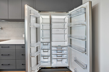 The refrigerator is open and has a lot of shelves