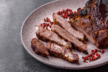 Grilled bone-in meat, beef tomahawk steak, juicy barbecued meat. Tomahawk steak