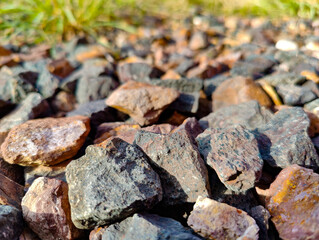 A pile of rocks sitting on top of a gravel ground