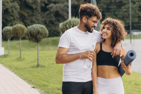Happy arab couple walking together after outdoor training - Powered by Adobe