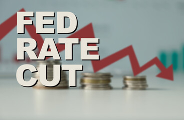 A newspaper clipping on a news headline titled 'Fed rate cut' on top of a downward falling graph, macro closeup view