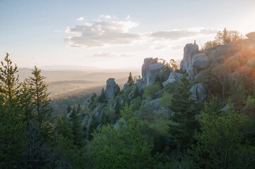 Fototapeta premium Bird's-eye perspective of rugged peaks surrounded by dense pine forests