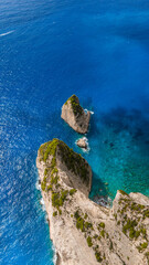 White Beach Zakynthos Greece aerial view of dramatic limestone cliffs with rocky islets surrounded by deep blue Ionian Sea and clear water
