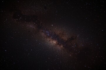 Fototapeta premium Colorful cosmic view featuring a field of stars and a nebula far beyond any planetary system.