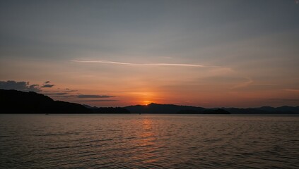 Fototapeta premium Sunset silhouette over the ocean horizon