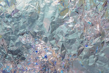 Glossy metallic silver foil backdrop, wrapping paper design pattern.