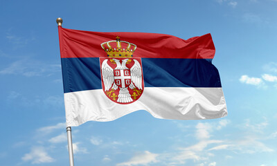 Naklejka premium Serbian national flag waving in the sky