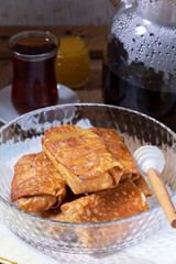 Pancakes with cottage cheese and raisin filling, served with honey and black tea. Traditional treat for Maslenitsa or Carnival.