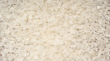 Raw flattened rice textured background. Dry rice flakes or poha pattern, Indian breakfast food