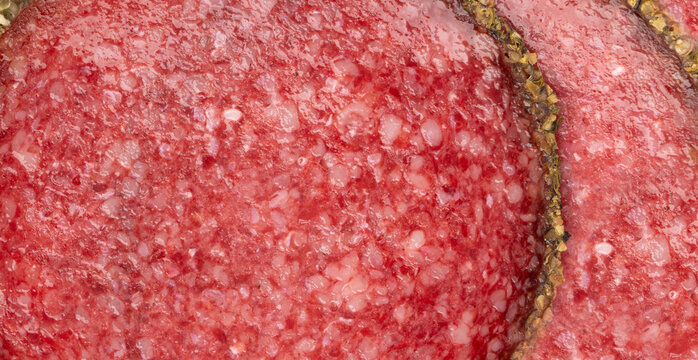 Pepper salami cuts isolated, thin sausage slices. Sliced dry chorizo, sausages round pieces