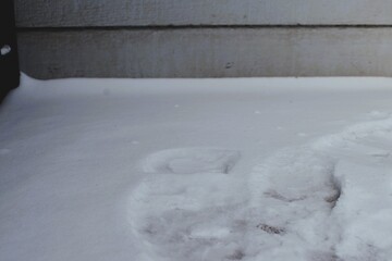 Melted Footprints in Snow by Exterior Wall