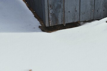 Snow Drift Against Wooden Fence in Winter