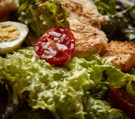 Fresh green salad with grilled chicken tomato egg and lettuce leaves