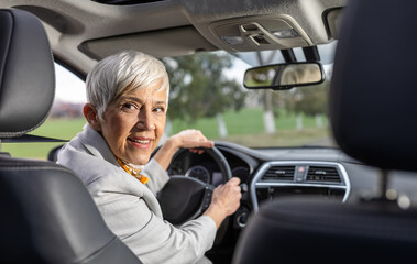 Woman sitting in car and looking back