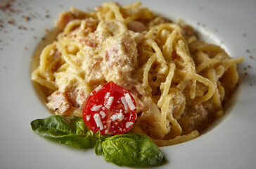 Spaghetti with tomato and parmesan cheese served on white plate