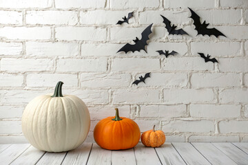 White and Orange Pumpkins with Bats on White Brick Background