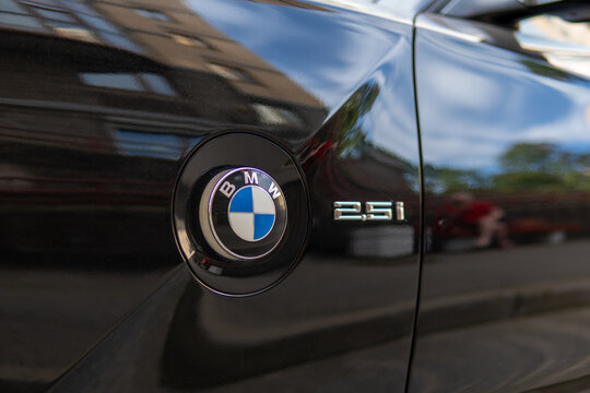 BMW Z4 I E85/E86 black color parked on street. Exterior of black BMW Z4 I (E85/E86) sport convertible coupe manufactured by the German automobile manufacturer on parking lot. 