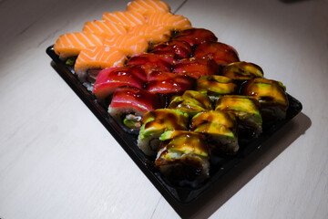 Sushi roll Philadelphia . Traditional delicious fresh sushi roll set with reflection . Sushi menu. Japanese kitchen, restaurant. different types of sushi