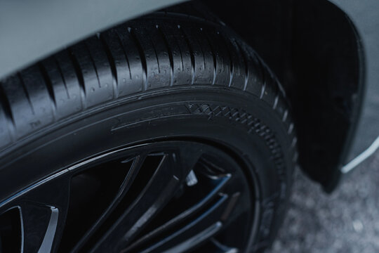 Fototapeta Car tire showing clean rubber surface and detailed tread pattern. Concept of automobile safety, vehicle maintenance and car service.