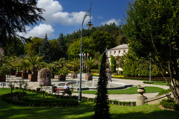 Obraz premium Kudowa Zdroj, Poland 09 09 2025: garden, palms, sanatorium and promenade in spa town Kudowa Zdroj Poland