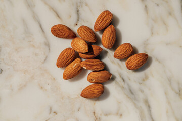 handful of almonds on white marble