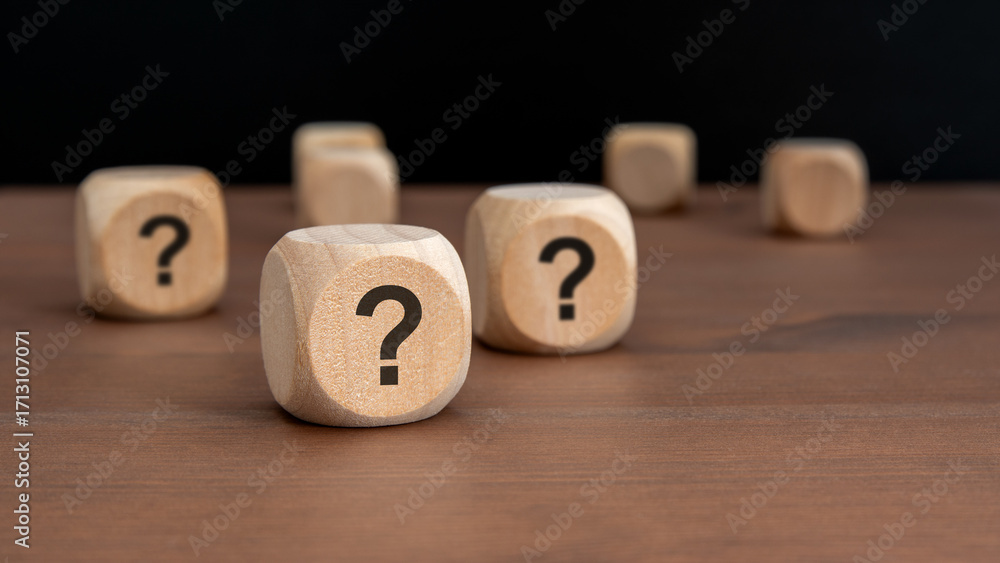 Poster three wooden blocks with question marks over a black background with copy space