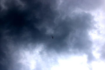 Airplane flying through cloudy gray sky
Airplane flying among gray clouds on a cloudy day, symbolizing travel, journey and freedom.