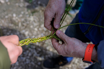 preparing for Easter by braided whip with willow as a tradition made by a father and son for whipping tradition