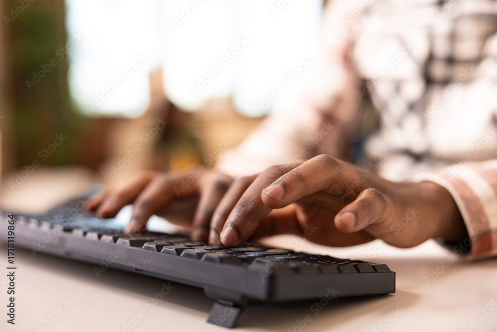 Poster african american entrepreneur typing on computer keys to update reports and reply to emails. black m