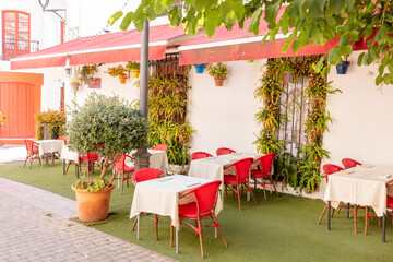 Estepona, Malaga, Andalusia, Spain. 3 September 2025. Outdoor restaurant terrace with tables and chairs