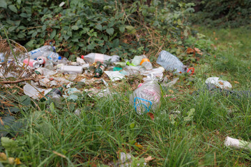 Garbage and plastic litter polluting forest and nature environment