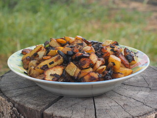 roasted chicken with potatoes Vegetables cooked in a cauldron over an open fire