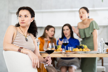 Group of girlfriends at party scold their friend. Quarrel at a bachelorette party