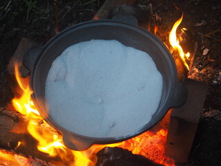 fire in a fireplace The first firing of the cauldron over an open fire with table salt