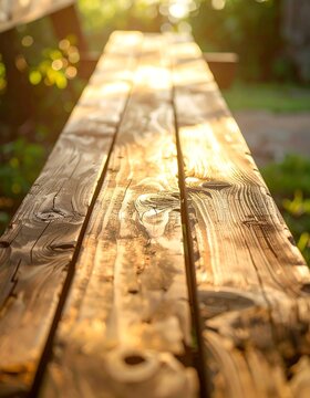 Wooden picnic table top bathed in golden sunlight