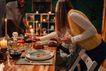Woman setting thanksgiving table with autumn decorations and candles