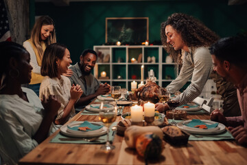 Friends celebrating thanksgiving enjoying roasted turkey