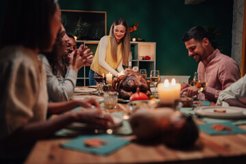 Family celebrating thanksgiving, enjoying roasted turkey dinner at home
