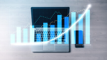 A modern workspace featuring a laptop and smartphone displaying financial growth statistics. The imagery includes data visualizations and trend charts. Impute