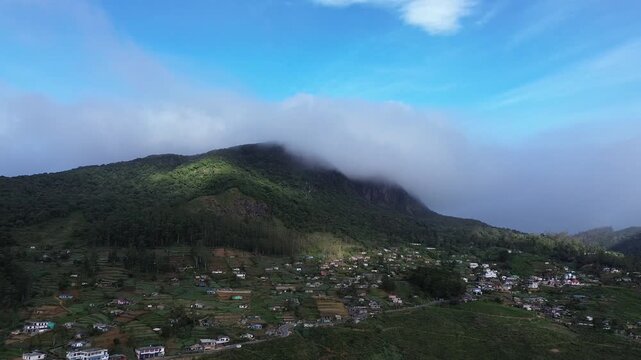 Stunning aerial panorama of the misty mountain ranges and lush green valleys in the highlands of Sri Lanka.