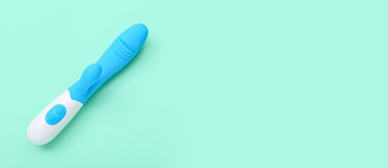 Rabbit vibrator from sex shop on turquoise background with space for text