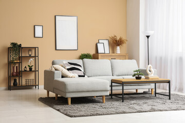 Interior of stylish living room with grey sofa, coffee table and picture