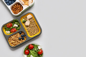 Healthy products in lunch boxes on light background. Diet concept