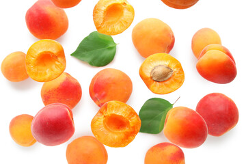 Flying apricots with leaves isolated on white background