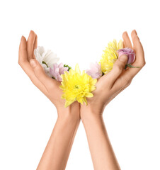 Female hands with beautiful flowers isolated on white background. Hand care concept