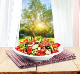 Tasty healthy fresh salad bowl with ingredients.