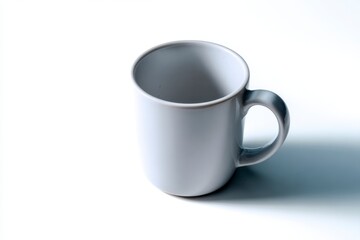 White ceramic mug on a white surface casting a soft shadow with a simple rounded handle